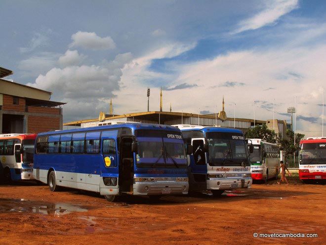 A couple of Cambodian buses parked in the bus yard, waiting to transport passengers.