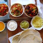 A table covered with the makings for roll-em-yourself tacos at La Cita, in Phnom Penh.