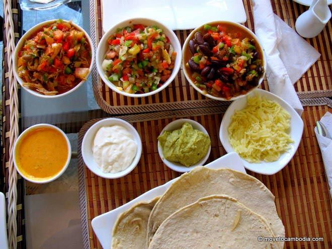 A table covered with the makings for roll-em-yourself tacos at La Cita, in Phnom Penh.