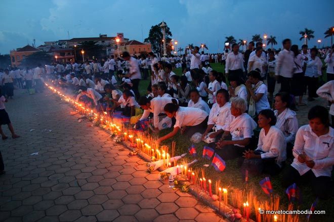 A row of flags, candles and joss sticks to commemorate King Father Norodom Sihanouk