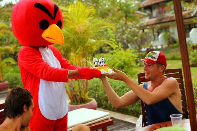 Andy receiving a birthday cake from an Angry Bird