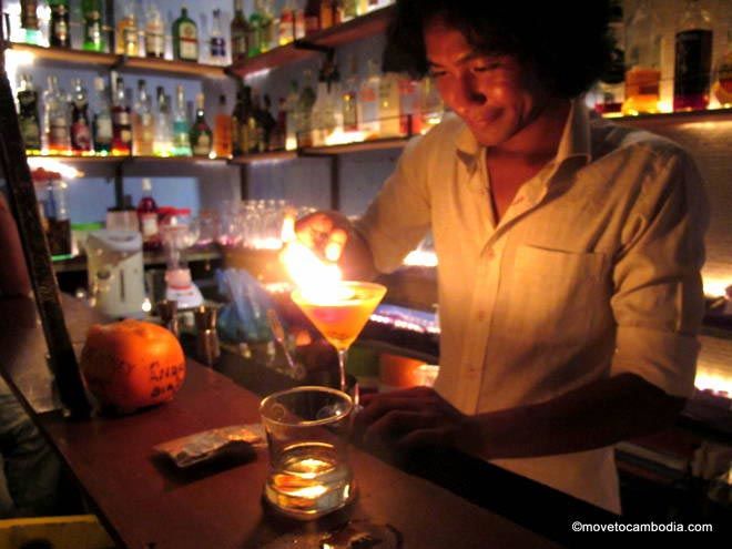 Hong Kry makes a drink with flair in a real tuk tuk at Siem Reap's Tuk Tuk Bar. 