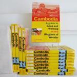 a stack of the Move to Cambodia paperbacks