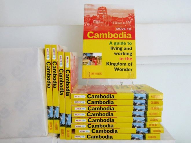 a stack of the Move to Cambodia paperbacks